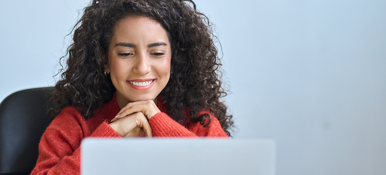 image of woman smiling at a computer